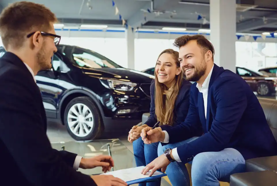 Financing representative assisting a customer at EZ Own Auto
