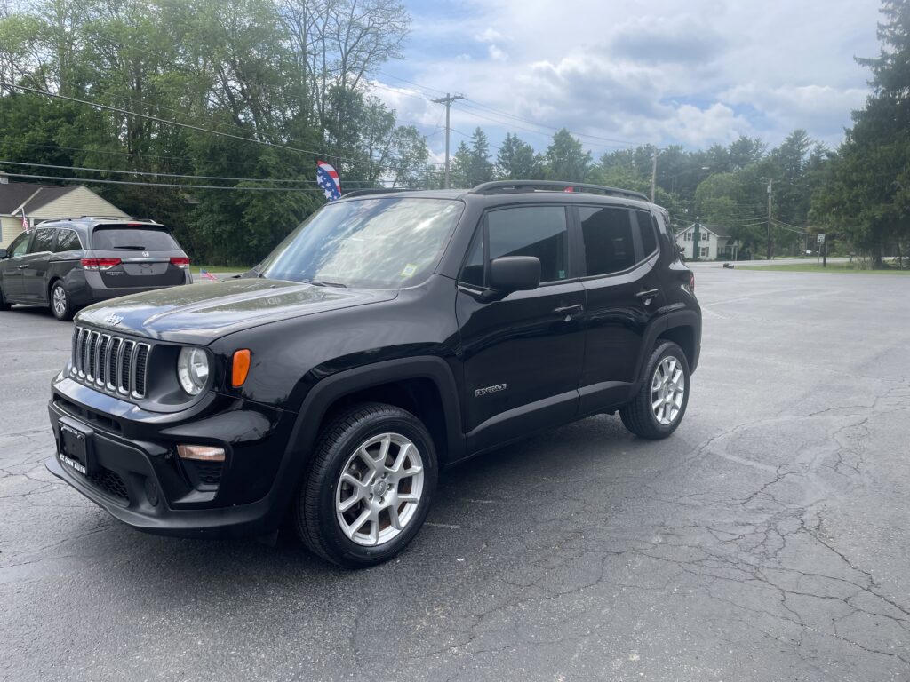 Front-right view of a black Jeep Renegade parked in a lot with American flag decorations